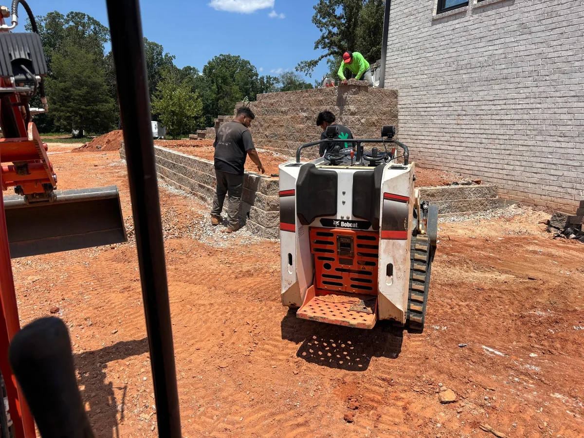 Infinite Outdoor Construction crew building a retaining wall