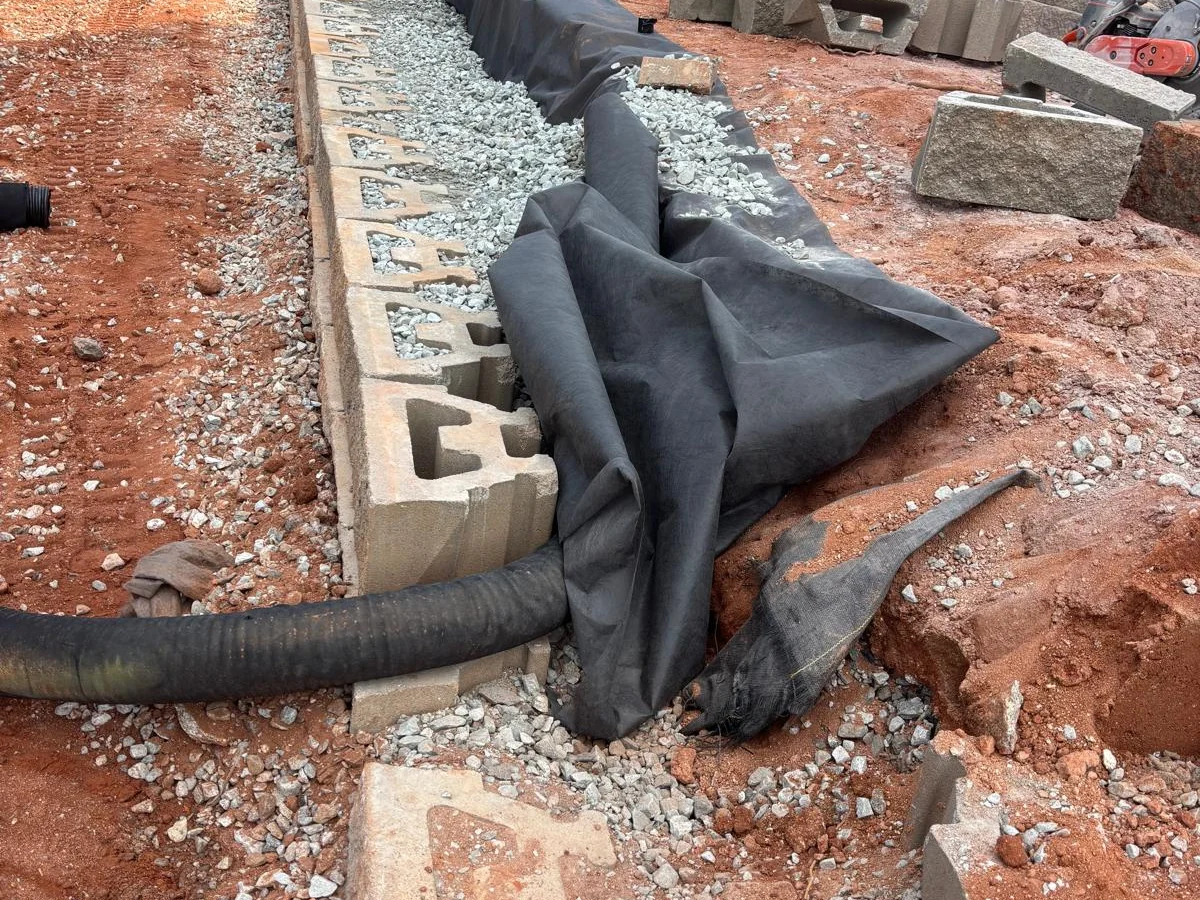 Retaining wall drainage and base preparation detail