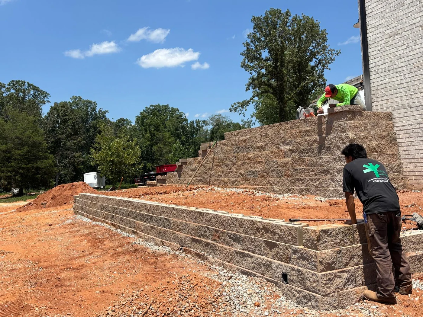 Tiered retaining wall installation beside a home in Upstate South Carolina